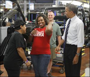 President Obama visits with Merle Stokes, left, and Nicole Jones at Chrysler’s Toledo Assembly complex.