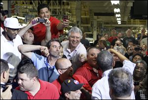 President Obama greets the crowd during a stop at Chrysler’s Toledo Assembly complex. Many workers took the time to thank the President for saving their jobs.