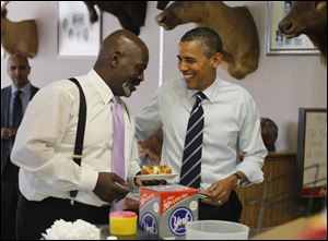 Toledo Mayor Mike Bell and the President enjoy lunch at Rudy’s Hot Dog on Sylvania Avenue. It was the first stop for Mr. Obama’s motorcade after arriving in Toledo.