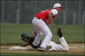 Allen Park’s Mark Turner is tagged out by Bedford third baseman Troy Przybylek in the first game of the Saline regional.
