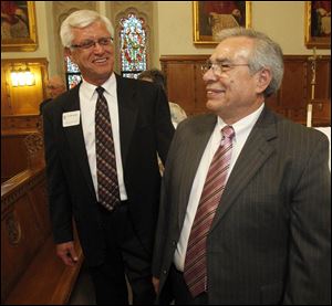 Benemerenti Medal winners Jack Altenburger of Toledo, left, and Deacon Alfredo Diaz of Fremont prepare to enter the cathedral in the procession.