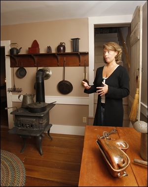 Renee Smith, museum curator, leads a tour of one of its homes on Sandusky Street in Findlay, where the museum complex is growing again.