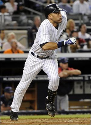 The Yankees' Derek Jeter runs to first as he flies out to right field during the fifth inning of a baseball game against the Cleveland Indians. Jeter was injured running to first and left the game.
