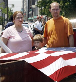 Monica Steele, her son Tristan, and husband Richard Steele of Toledo came to see the steel girder that was transported through Toledo Friday on its way to Wauseon.