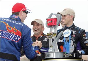 Teammate Kyle Busch congratulates Denny Hamlin for getting a victory for Joe Gibbs Racing. Busch had a solid afternoon too, finishing in third place.