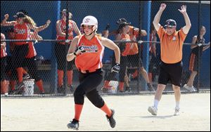 Summerfield softball coach Robert Taylor celebrates as Taylor Goodin (9) scores the winning run.