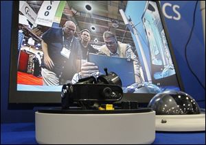 A security camera from Clinton Electronics gets a workout from participants at the recent loss prevention conference staged by the National Retail Federation at Grapevine, Texas.