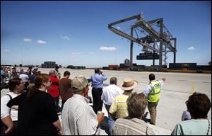 A container moves from one carrier to another at CSX's open house. The facility has 200 employees, most of them hired locally.