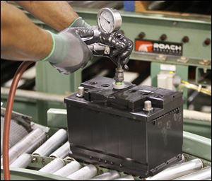 John Curtaindoll performs a pressure test on a battery at the plant. It is to produce 6 million batteries a year after the expansion. 