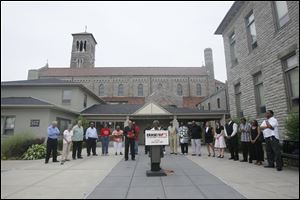 Reverend Shirley A. Sparks says a prayer at St. Martin de Porres Church. Church leaders from across Toledo gathered to pray and talk about the recent violence that has broken out across Toledo. 