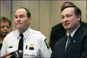 Police Chief Mike Navarre, left, announced rewards for information leading to arrest and conviction. Even so, there haven't been any more tips coming in than usual, said Capt. Wes Bombrys, right.
