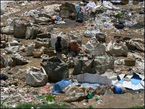 Dump workers, or reciclidores, sort through the trash they gathered from trucks.