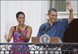 President Barack Obama and first lady Michelle Obama welcome military families to an Independence Day celebration on the South Lawn of the White House in Washington.