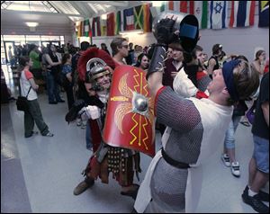 Marshall Lamming, left, and Levi Wonder, demonstrate a battle while waiting in a long line to get into the GarasuNoShiCon 2010 at Owens Community College in Perrysburg.