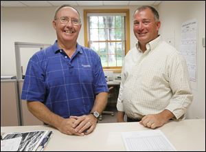 Jeff Ballmer, left, who retired as the head of Sylvania's department of public service, chats with Kevin Aller, who replaced him. Mr. Aller was assistant sanitary engineer with the Lucas County Sanitary Engineer's Office.