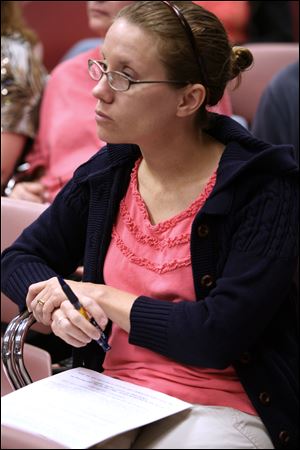 Jill Patton of Bowling Green is poised to take notes as she attends a seminar given by Joni Meyer-Crothers on couponing at the Wood County Public Library in Bowling Green.