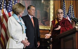 The Dalai Lama makes his remarks on Capitol Hill as he is welcomed by House Speaker John Boehner (R., Ohio) and House Minority Leader Nancy Pelosi (D., Calif.).