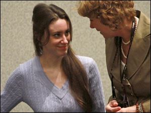 Casey Anthony, left, speaks to her attorney, Dorothy Clay Sims, before her sentencing hearing Thusday at the Orange County Courthouse in Orlando, Fla.
