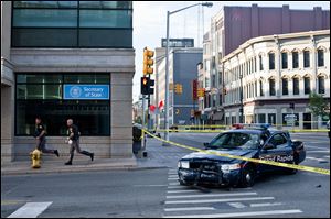 A Grand Rapids police car that was both hit and fired upon sits on the corner of Division and Fulton in Grand Rapids, Mich. after Roderick Dantzler led police on a high speed chase Thursday.