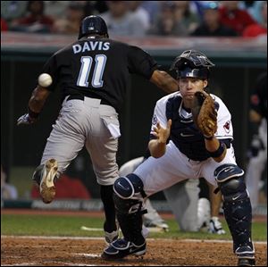 The Blue Jays' Rajai Davis (11) crosses the plate in front of the throw to Indians catcher Lou Marson in the sixth inning