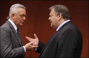 Italian Finance Minister Giulio Tremonti, left, speaks with Greek Finance Minister Evangelos Venizelos in Brussels.