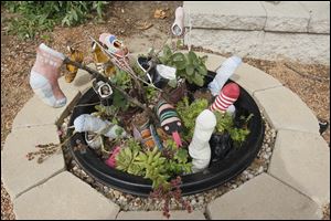 Shoes and socks blossom in the Stinky Feet Garden. It's the first full summer season for the library's garden.