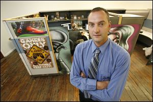 Tony Legeza, foreground, who co-founded Beyond Gaming in Toledo with Justin Yamek, background, says he would like to see a centralized hub with resources for business start-ups.