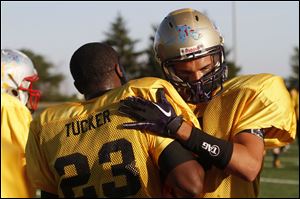 Dijon Tucker (23) congratulates teammate Jordan Lane after Lane scored the Gold squad’s first touchdown in its 17-6 All-Star victory.
