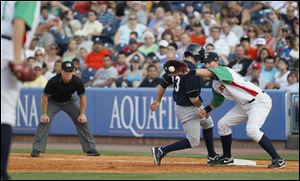 Hens’ first baseman Ryan Strieby takes a throw last night hoping to catch Yankees’ base runner Austin Krum before he can get back.