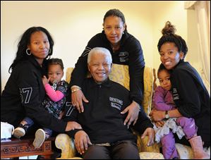Former South Africa president Nelson Mandela, center, celebrates with family members left to right Zaziwe Manaway, Ziphokazi Manaway, Zamaswazi Dlamini and Zamak Obiri at Mandela's hometown in Qunu, South Africa.