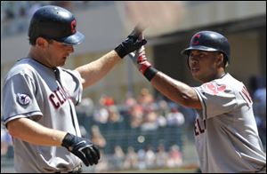 Cleveland Indians' Austin Kearns, left, is congratulated by Luis Valbuena after his solo home run off Minnesota Twins' Matt Capps in the ninth inning of the first baseball game of a doubleheader Monday.