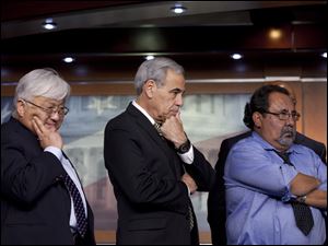 From left, Reps. Stan Honda, D-Calif., Charles Gonzalez, D-Tex. and Raul Grijalva, D-Ariz., listen Wednesday during a minority caucuses news conference on Capitol Hill in Washington.