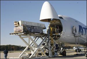 Cargo to be sent to Sydney, Australia, is loaded onto a plane at the BAX global cargo sorting hub at Toledo Express Airport in this file photo.
