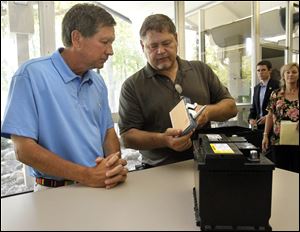Gov. John Kasich speaks with Bob Snow, Johnson Controls plant manager. Mr. Kasich was at the groundbreaking ceremony for the company's 220,000-square-foot expansion project in Spencer Township.