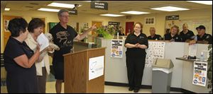 Dog Warden Julie Lyle, center, and staff listen as county Commissioners Tina Skeldon Wozniak, left, Carol Contrada (holding Q-tip), and Pete Gerken address the crowd.