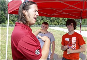 Adam Andretti, a race car driver and a nephew of star Mario Andretti, discusses road rage as students David Wood, center, of Holland and Robert Shaffer of Bowling Green pay attention. The star power of big names conducting the sessions was a big draw.