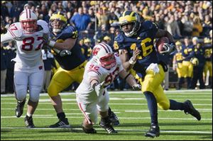 Wolverines’ quarterback Denard Robinson will have to shift from a spread offense to a pro-style under coach Brady Hoke.
