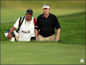 Michael Allen, right, with his caddie, Mike Kerr, approach the 18th green at Inverness Club. Allen is tied with Marl Calcavecchia and Joey Sindelar for third place in the U.S. Senior Open.