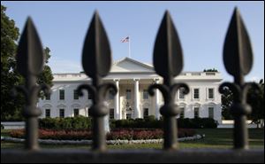 The White House is shown in the background as the debt crisis remains unsolved, just three days before the nation could go into default.