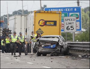 A Toyota Camry driven by Jodi Lubas, 40, of Maumee, is among several vehicles involved in a pair of collisions on I-475/U.S. 23. Ms. Lubas, who had stopped to provide assistance to victims of an earlier crash, was standing on the highway when she was struck and killed.