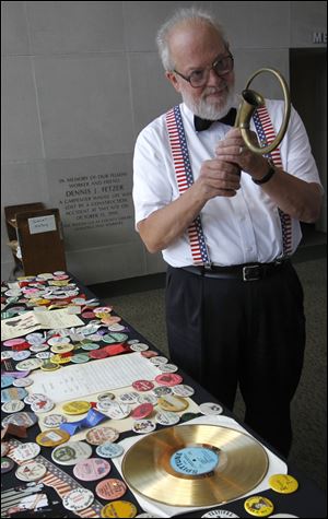 Ray Heitger, founder of the Cakewalkin' Jass Band, organized in 1967, shows a horn he used to call the band back together after a break during their years at Tony Packo's.