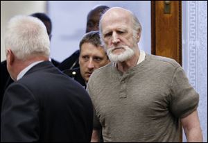 Robert Bowman enters Lucas County Common Pleas Court in Toledo for his trial Thursday.  He is charged with the 1967 murder of Eileen Adams. 