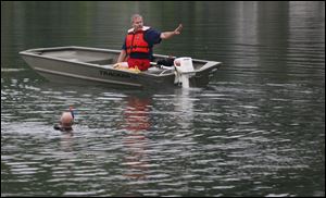 Rescuers search the pond.