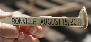 Officials hammered gold-painted spikes into freshly built rail track yesterday to dedicate the multimodal facility.