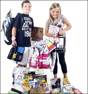 Luke Alzapiedi, left, and Sydney Ferguson, right, model the newest school gear.