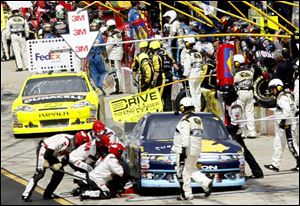 Greg Biffle’s crew changes tires on his car during a stop in yesterday’s Pure Michigan 400. Biffle had a tough day, finishing 20th, which leaves him 13th in overall points.