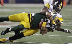 Pittsburgh Steelers linebacker Lawrence Timmons (94) tackles Green Bay Packers player Andrew Quarless (81) during the second half of the 2011 Super Bowl, in Arlington, Texas.
