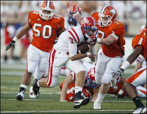 Andy Meinert of St. Francis is tackled by Nick Josza of Southview in Friday night’s game at the Glass Bowl. The Cougars started the season 1-0.
