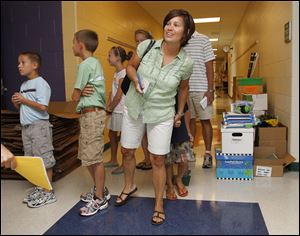 Tricia Cowell peeks into a classroom during a tour of the new Beverly School. Birmingham, Riverside, Old Orchard, and Walbridge school buildings also are new.