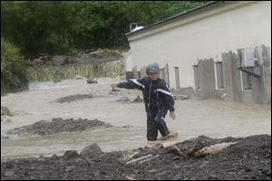 A Taiwanese man wades through a flash flood triggered by typhoon Nanmadol in Manchu, Pingtung County, Southern Taiwan Monday.